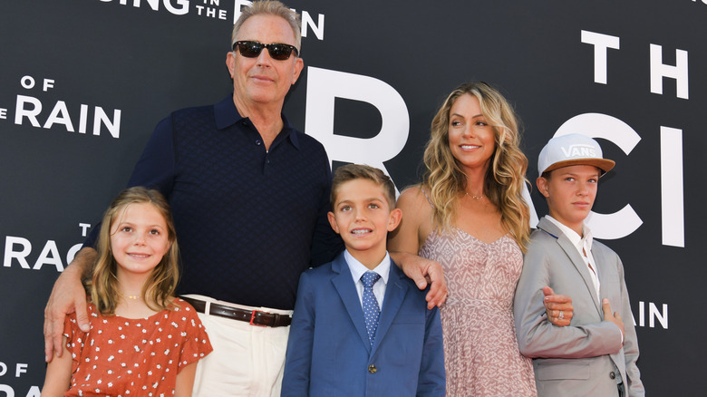 Kevin Costner and Christine Baumgartner posing with their kids