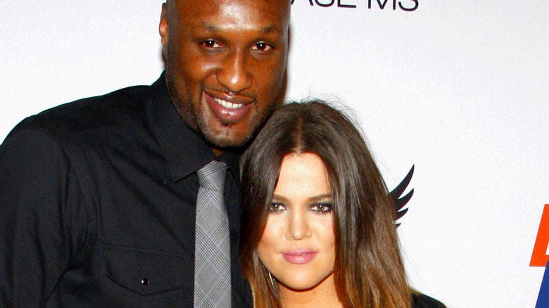 Khloé Kardashian and Lamar Odom smiling on red carpet