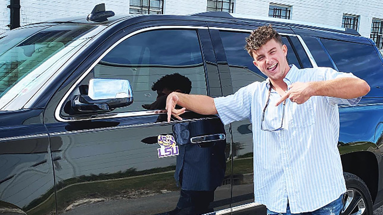 Kyle Dickard posing with car