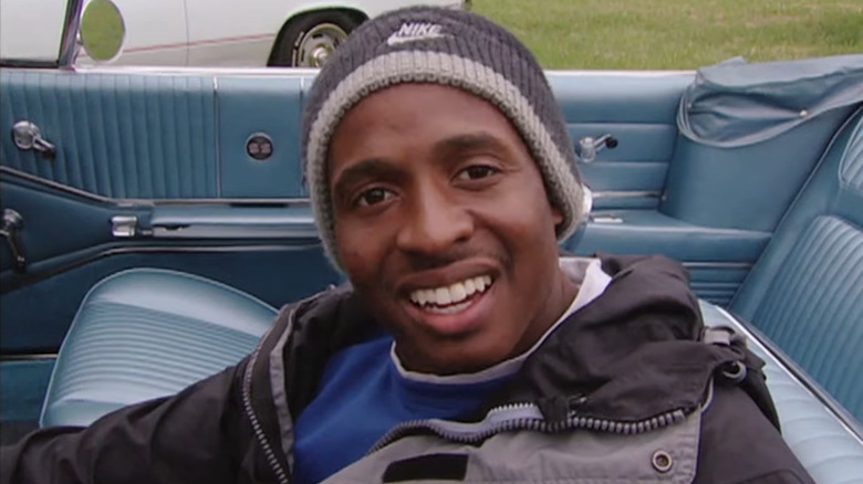 Tim Montgomery smiling inside a car