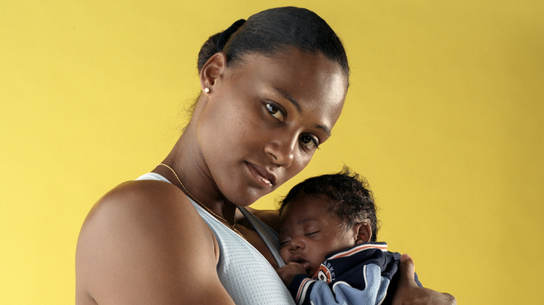 Marion Jones holding son