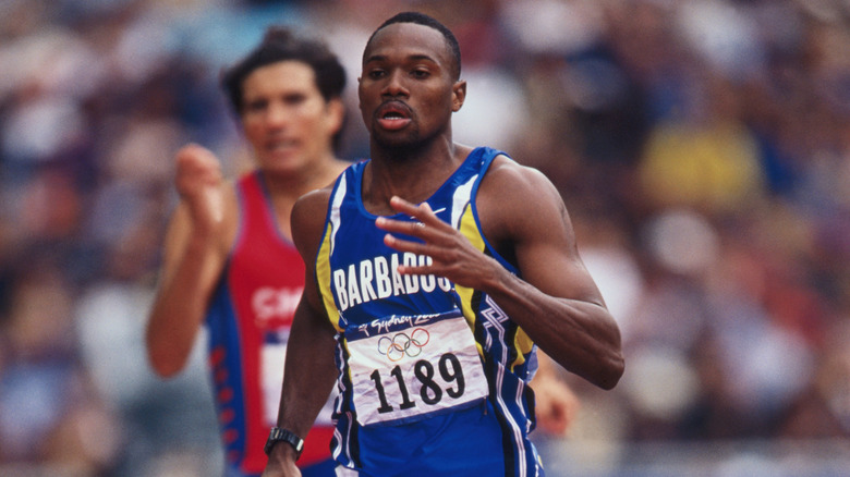 Obadele Thompson running with competitor behind him