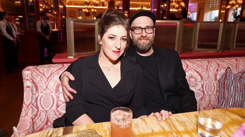 Mayim Bialik and Jonathan Cohen at a table