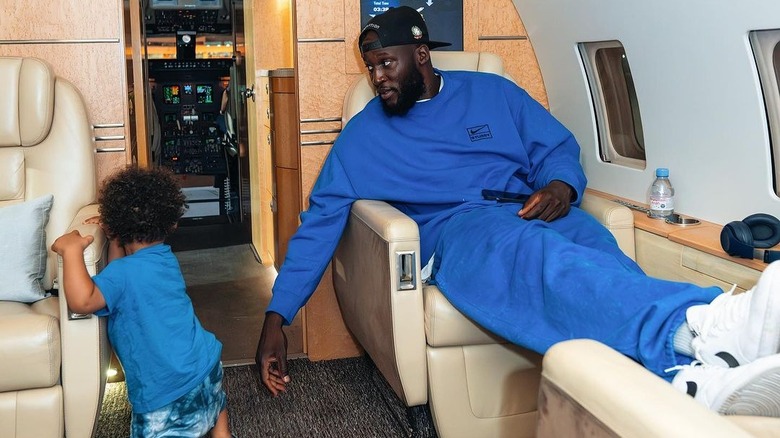 Romelu Lukaku with his son on private jet