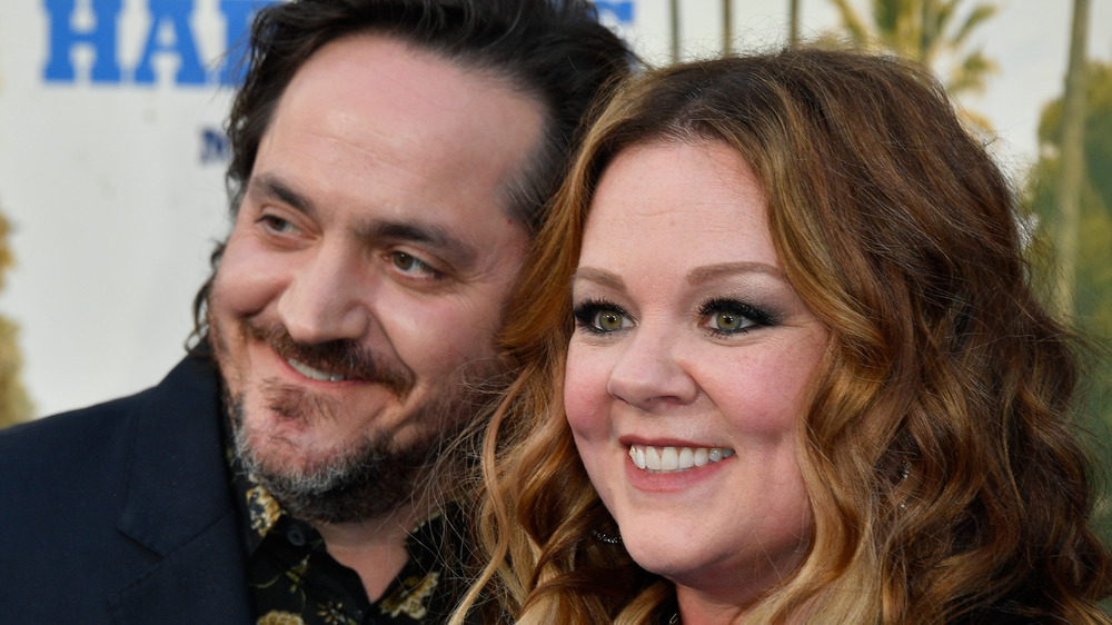 Ben Falcone leans on Melissa McCarthy on the red carpet 