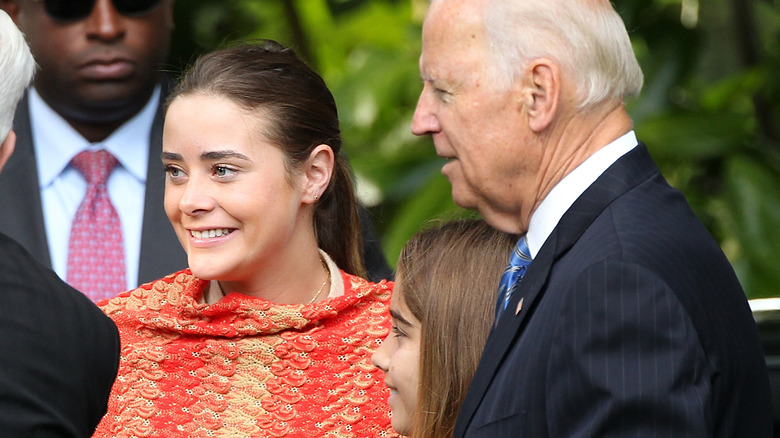 Naomi Biden smiling with her grandfather and others