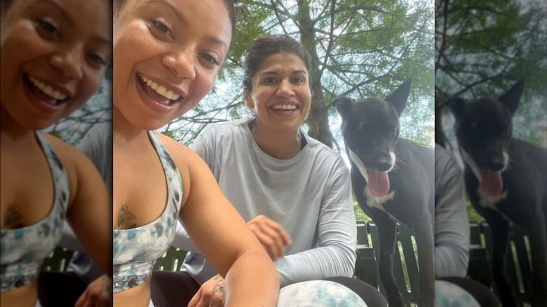 Shalita Grant and Jessica Aguilar outside with dog