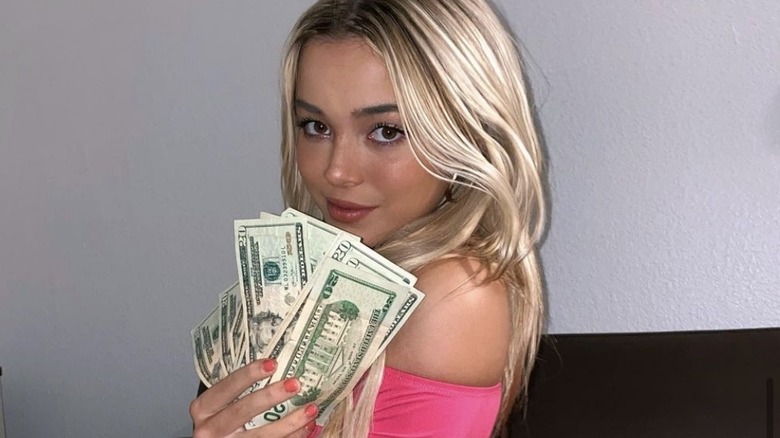 Olivia Dunne holding a stack of money