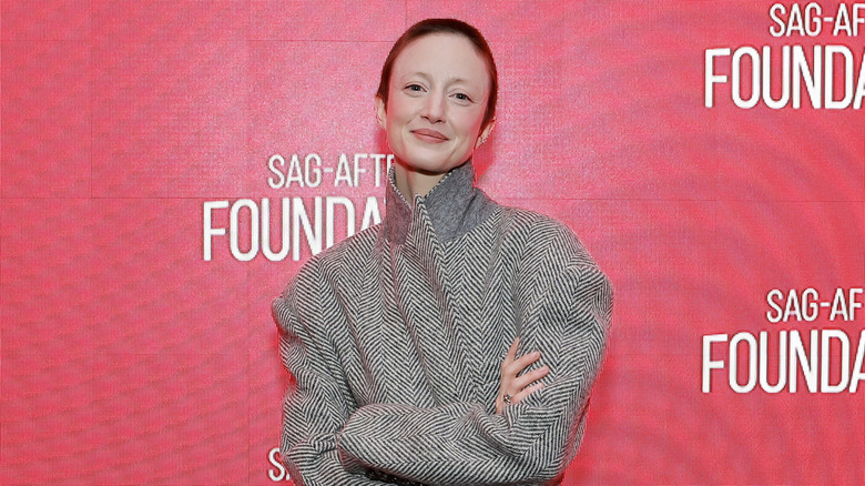 Andrea Riseborough smiling, arms crossed