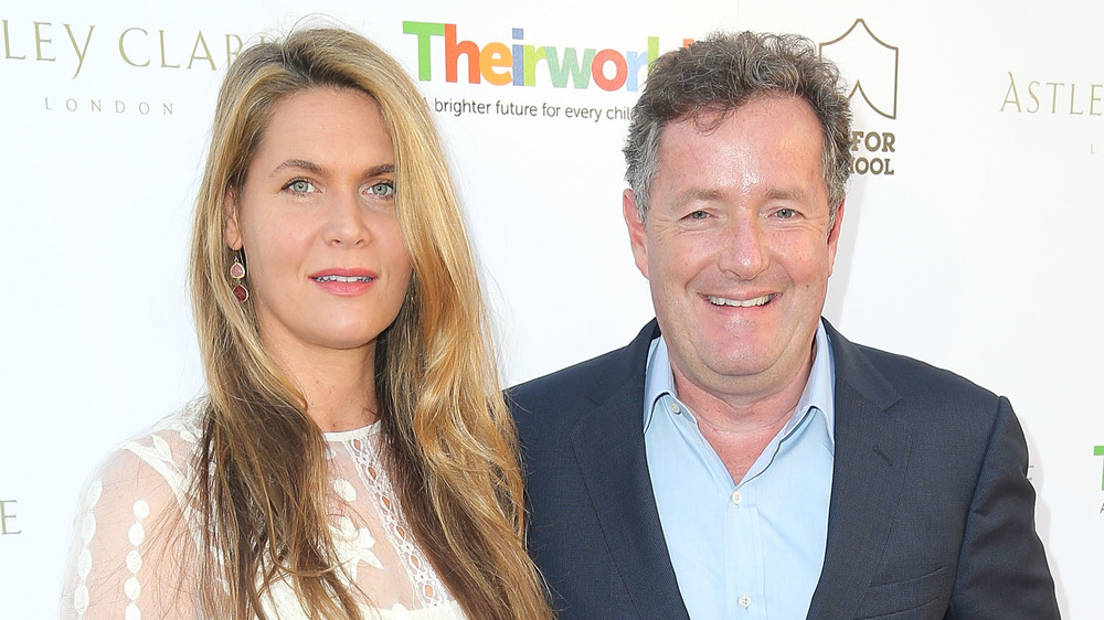 Celia Walden and Piers Morgan posing on the red carpet