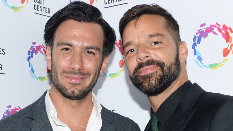 Jwan Yosef and Ricky Martin posing on red carpet in suits