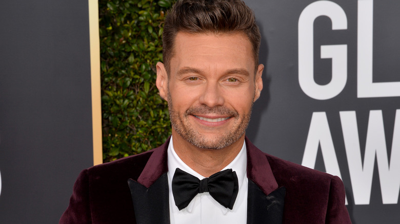 Ryan Seacrest smiling in bowtie at the Golden Globes