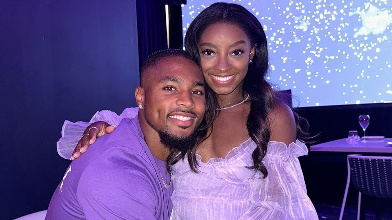 Simone Biles with arm around Jonathan Owens