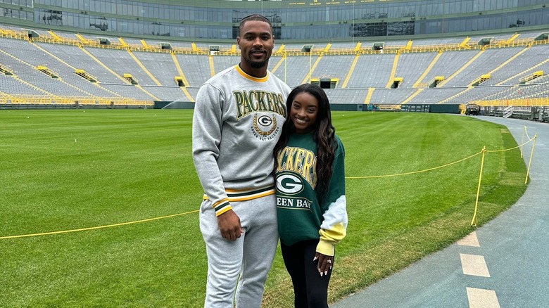 Jonathan Owens, Simone Biles posing in Lambeau Field