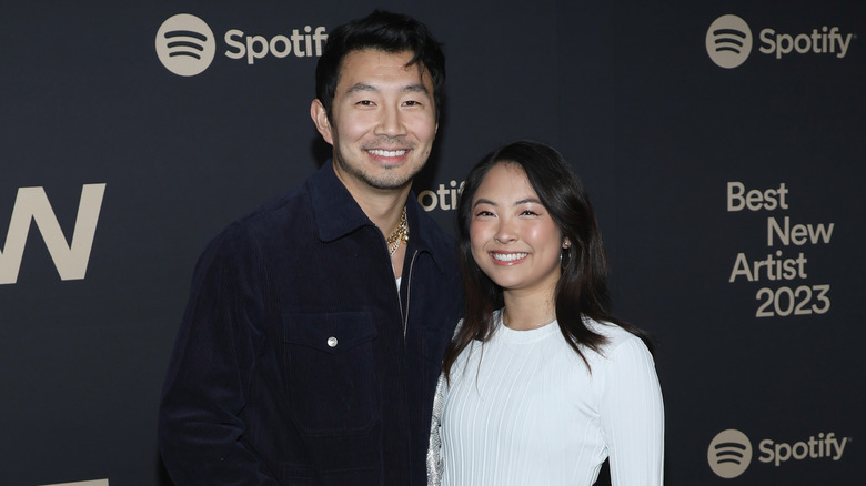 Simu Liu and Allison Hsu smile and pose together