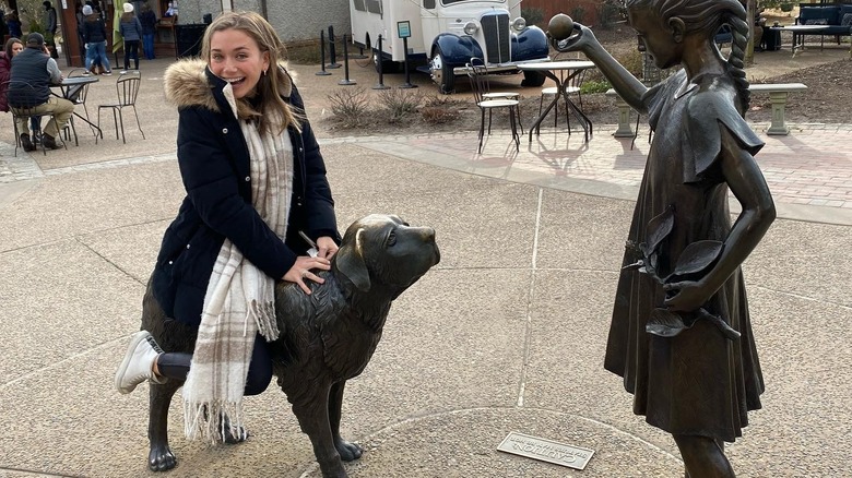 Cameron Liss sitting on a statue