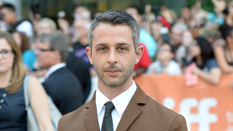 Jeremy Strong wearing brown suit