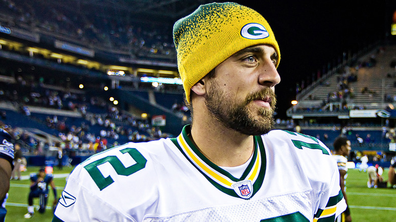 Aaron Rodgers wearing Green Bay Packers uniform and knit cap