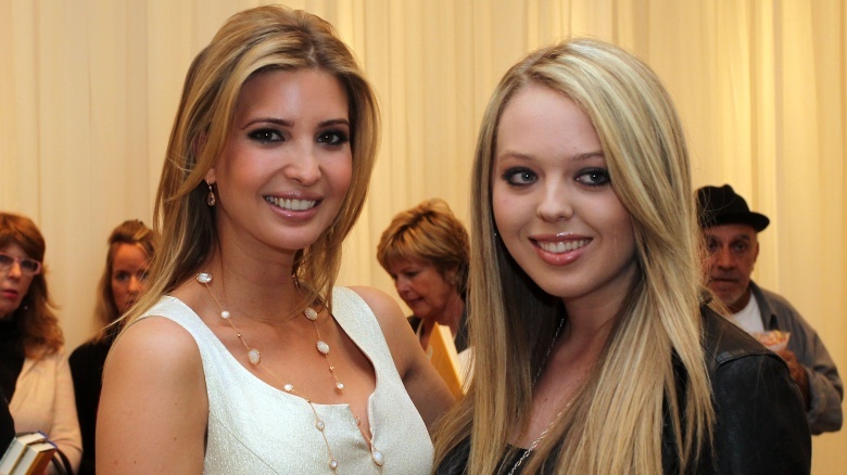 Ivanka Trump in a white dress, Tiffany Trump in a black outfit, both smiling