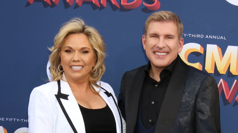 Todd and Julie Chrisley smiling on the red carpet 