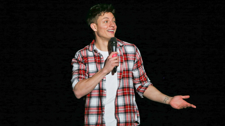 Matt Rife holding a microphone