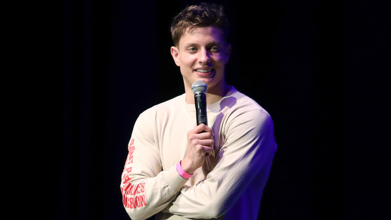 Matt Rife holding a microphone