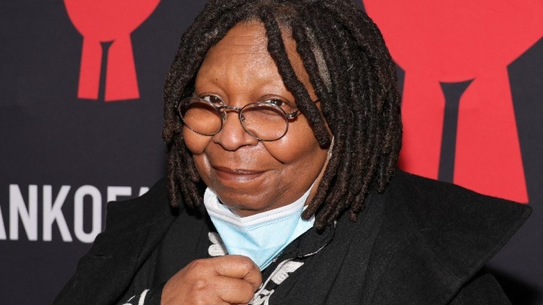 Whoopi Goldberg with face mask pulled down