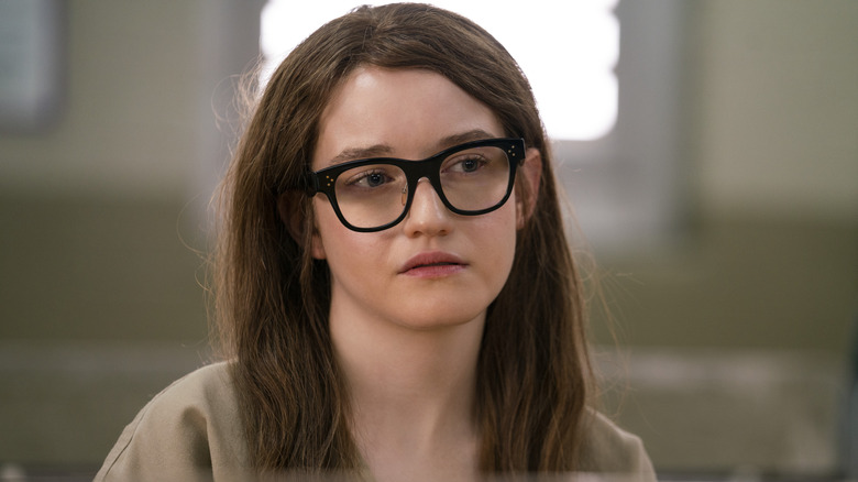 Anna Delvey black glasses red hair prison