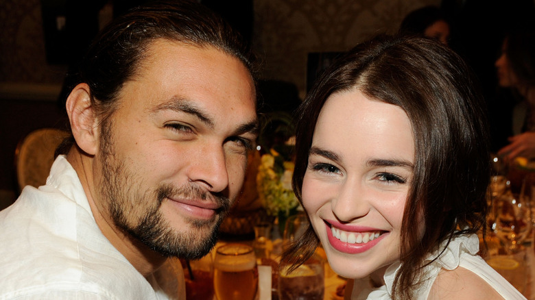 Jason Momoa and Emilia Clarke smiling