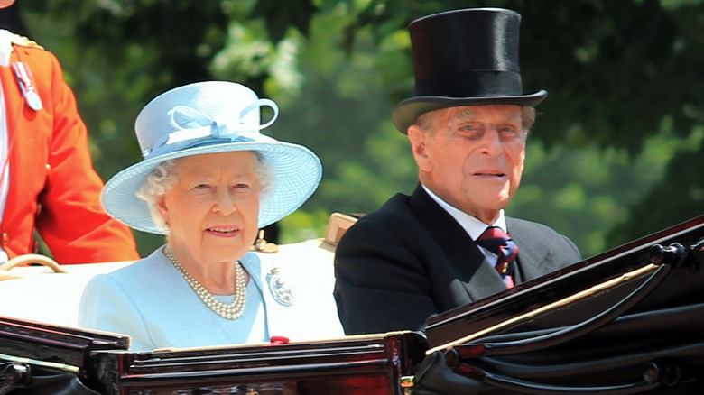 Queen Elizabeth and Prince Philip ride in a carriage in 2017