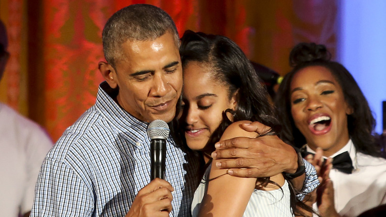 Barack Obama hugging Malia Obama