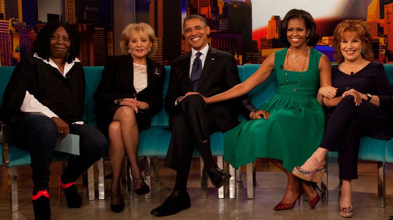 Whoopi Goldberg, Barbara Walters, Barack Obama, Michelle Obama, and Joy Behar sit on the set of The View
