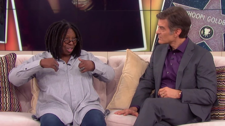 Whoopi Goldberg with Dr. Oz, speaking on couch