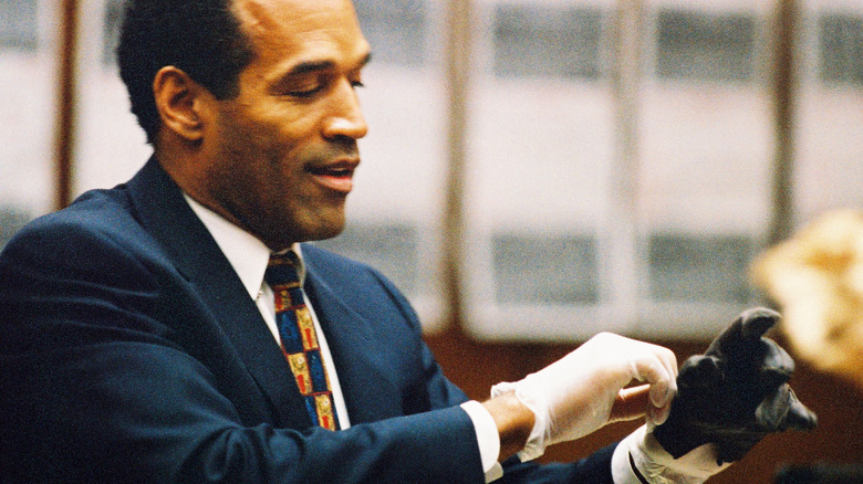 O.J. Simpson trying on gloves