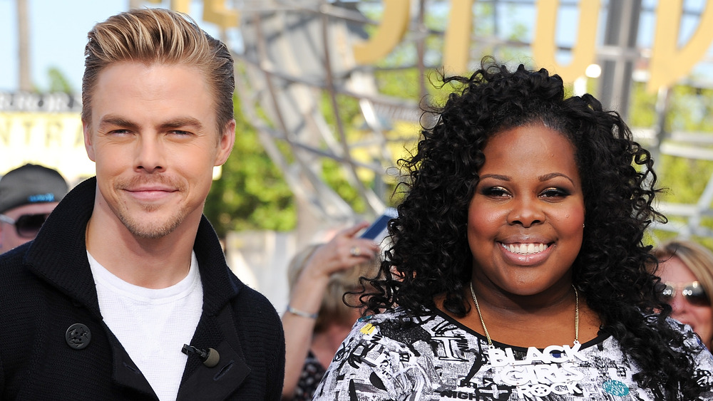 Derek Hough and Amber Riley posing