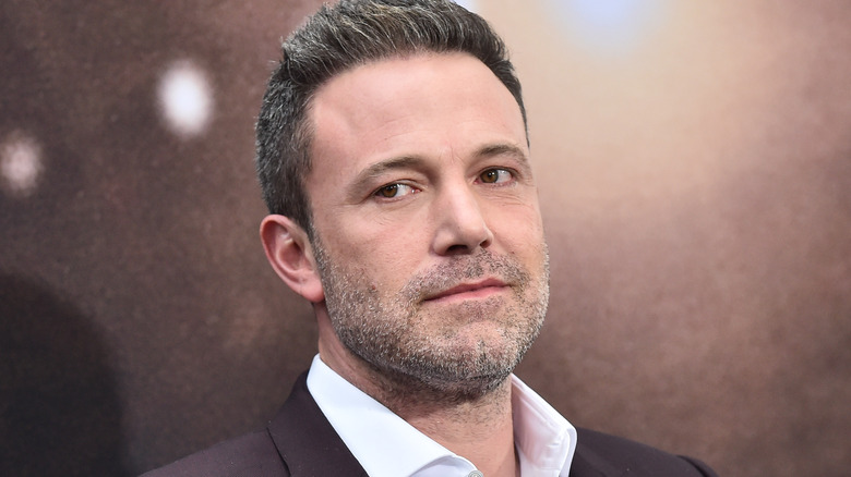 Ben Affleck with serious expression on the red carpet