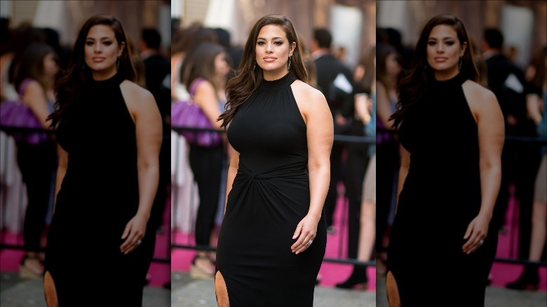 Ashley Graham walks in a black dress in June 2016