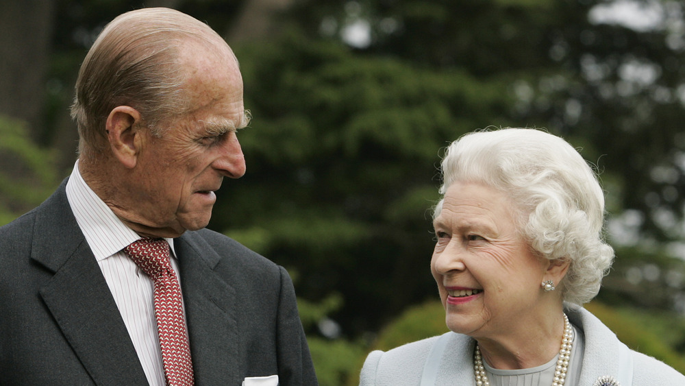 Prince Philip and Queen Elizabeth II smiling at each other