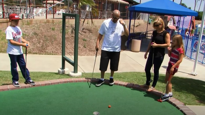 Brandi Passante and family playing mini golf