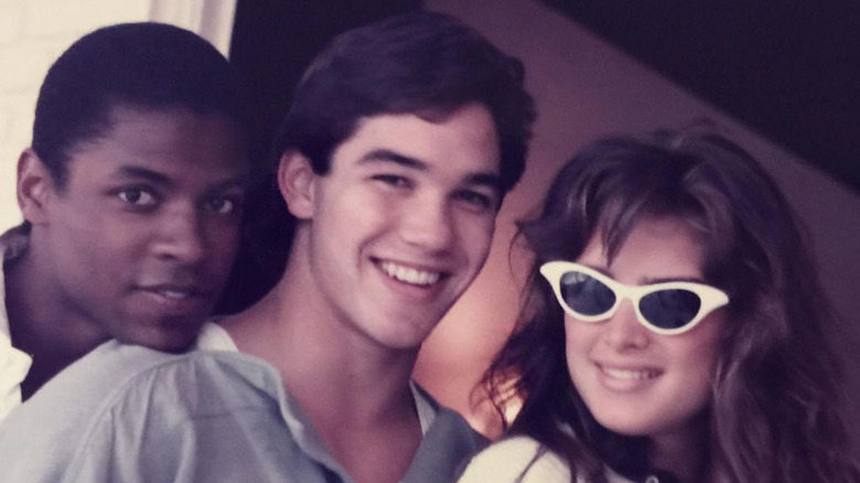 Dean Cain and Brooke Shields pose with a college friend