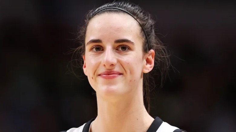 Caitlin Clark wearing a headband and ponytail