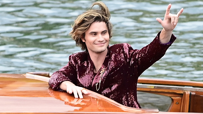 Chase Stokes smiling on a boat