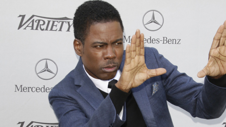 Chris Rock posing with hands up