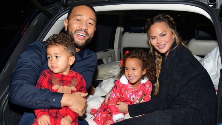 John Legend and Chrissy Teigen posing with Miles and Luna