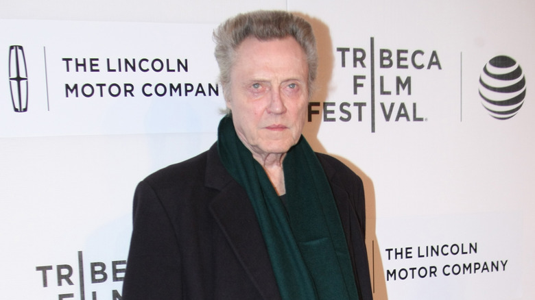 Christopher Walken in a green scarf and black coat