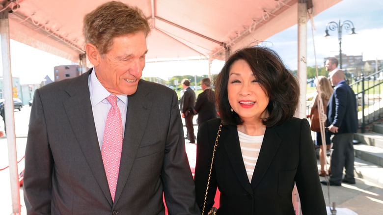 Maury Povich and Connie Chung holding hands at an event