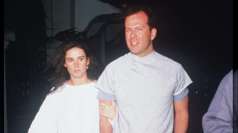 Demi Moore holding Bruce Willis arm