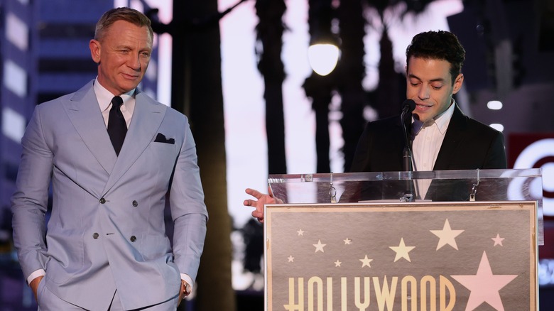 Rami Malek speaking beside Daniel Craig