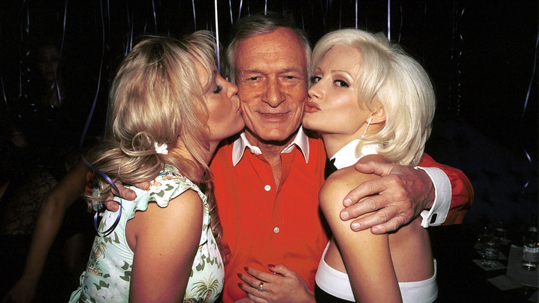 Holly Madison with short hair kissing Hefner