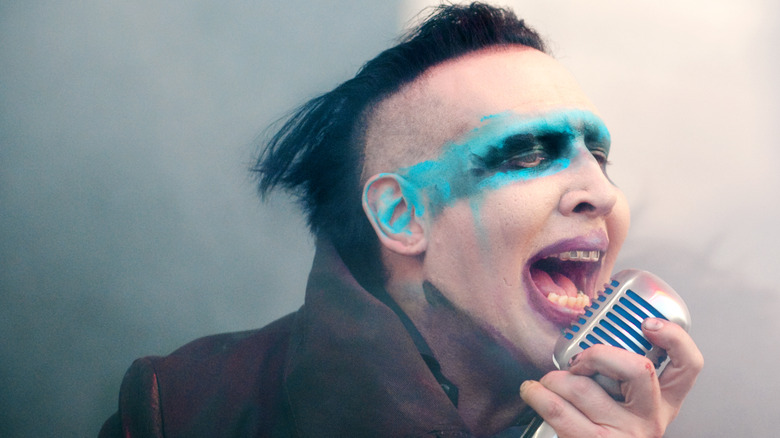 Marilyn Manson wears blue eye makeup on stage